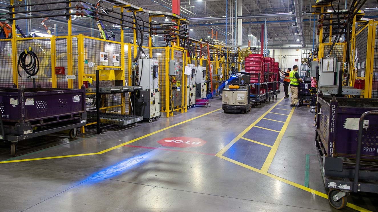 Workers in an automotive parts manufacturing facility