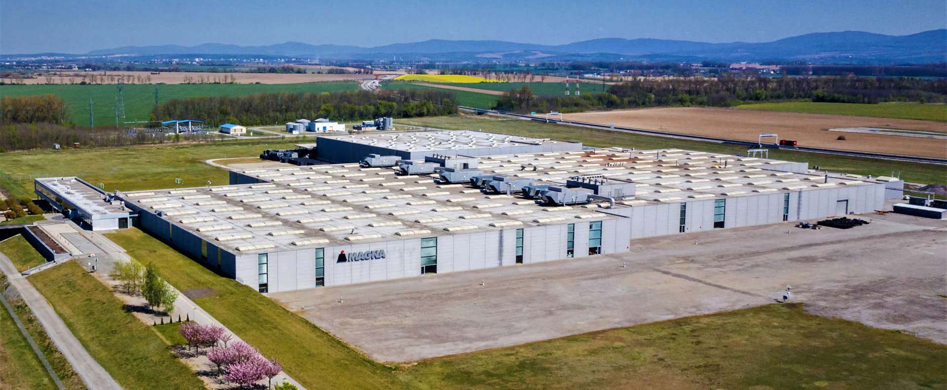Aerial view of large Magna automotive manufacturing facility in rural area