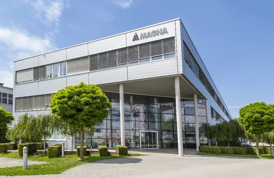 Modern office building with Magna logo on the facade