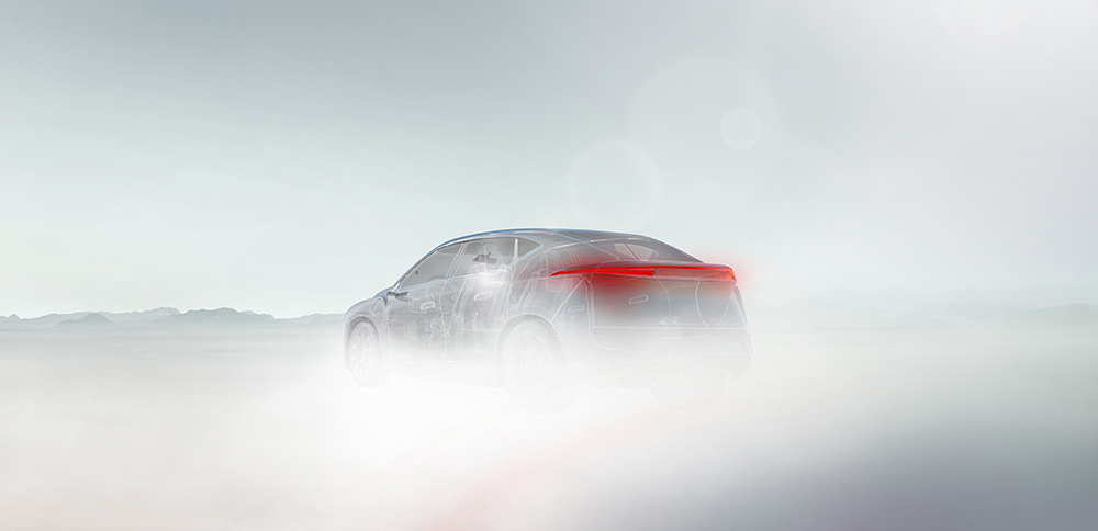 Ghosted vehicle on a fog covered road with mountains in the foreground