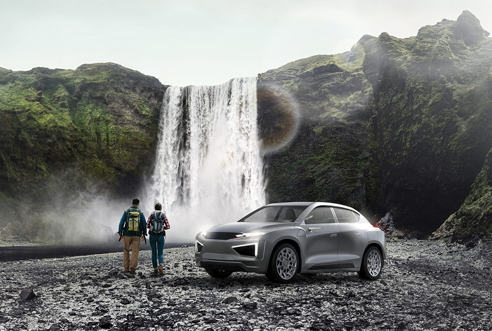 2025-Magna-Sustainability-HR-01 Two people standing beside a vehicle looking at a waterfall